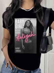 A Female Figure With An Aura Of Confidence And Modern Elegance, Highlighted By Luminous Pink Text That Conveys Energy And Freedom. A Casual Women's T-Shirt Perfect For A Contemporary Urban Look. - 黑色 - 查看 1