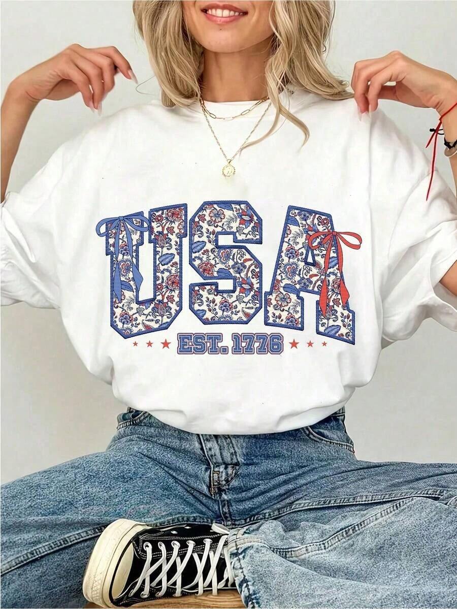 Women's 100% Cotton T-Shirt With Floral Bow Graphic Print, Soft USA EST 1776, Aesthetic Patriotic Flirty Top, Y2K Style For The 4th Of July, Soft And Breathable Summer Clothes, Urban Casual Wear, Unique Gift For Her. - 白色 - 查看 1