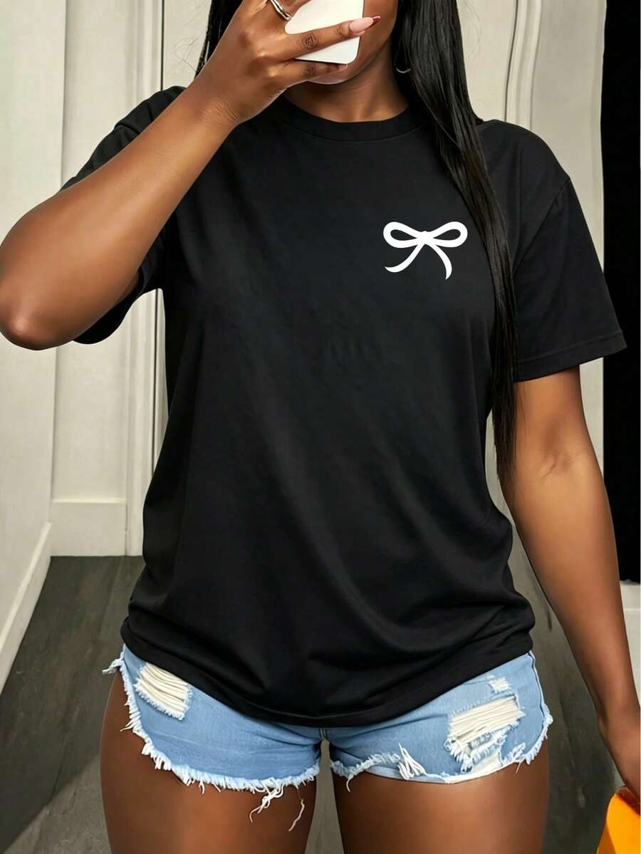 Camiseta informal y bonita de mujer con estampado de lazo, ideal para el verano. Cuello redondo, mangas cortas, corte regular, tejido ligeramente elástico, versátil para el uso diario. - Negro - Ver 1
