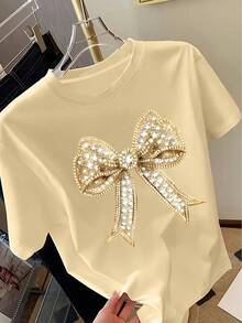 Camiseta de mujer con estampado de lazo Y2K - Camiseta de manga corta con cuello redondo y patrón decorativo brillante, Top casual de primavera/verano con cuello redondo, Camiseta de mujer, Estilo regular - Albaricoque 1 - Ver 2