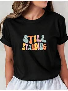Camiseta Deportiva Casual para Mujer de Manga Corta con Colorido Texto STILL STANDING - Camiseta Elástica de Cuello Redondo, Lavable aáquina, Ajuste Cómodo y Perfecta para Todas las Estaciones. - Negro - Ver 1