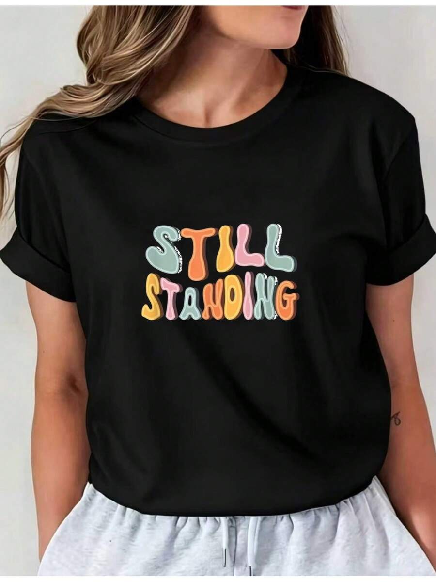 Camiseta Deportiva Casual para Mujer de Manga Corta con Colorido Texto STILL STANDING - Camiseta Elástica de Cuello Redondo, Lavable aáquina, Ajuste Cómodo y Perfecta para Todas las Estaciones. - Negro - Ver 1