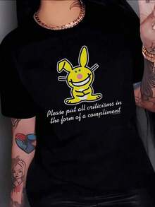 Women's 100% Cotton T-Shirt. Smiling Yellow Rabbit With Long Ears Conveying A Positive And Encouraging Message To Face Criticism With Humor. Women's T-Shirt. 100% Cotton. - Hitam - View 1