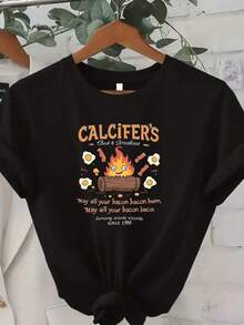 Playera de Algodón Puro Unisex Estampada CasualCamiseta única y original con diseño de Calcifer fuego y desayuno inspirado en la cultura pop y2k ideal para amantes del buen humor y la comida divertida, perfecta para destacar tu estilo único y divertido en cualquier ocasión.Cómoda y versátil para escuela, trabajo, salidas y eventos casuales - Negro - Ver 1