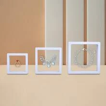 A Transparent Film Suspended Jewelry Packaging Display Box, Available In Multiple Colors, Includes A Matching Paper Outer Box. It Can Store Rings, Earrings, Bracelets, And Other Types Of Jewelry. Features Scratch-Resistant And Dust-Proof Design, Combining The Functions Of Store Display And Holiday Gift Packaging. A Simple And Practical Universal Jewelry Storage Box - White Film Box; 11*11 - View 2