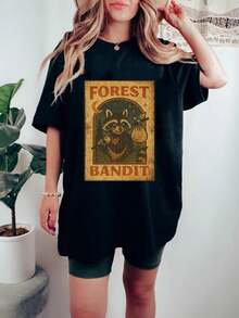 Una camiseta de manga corta para mujer, moderna, a la moda, retro, casual y holgada, adecuada para actividades al aire libre en primavera y verano, con un estampado de mapache ladrón del bosque.La camiseta casual de mujer con estampado de animal de dibujos animados retro es una prenda de verano nueva, moderna y a la moda, una camiseta negra versátil.blusas para mujer,blusas casuales para dama,tops,, mujer premium,y2k,playeras de mujer curvy,ofertas y liquidaciones ropa mujer,playeras deportivas para mujer,,playeras de hombre, mujer,blusas>elegante C4IY - Negro - Ver 1