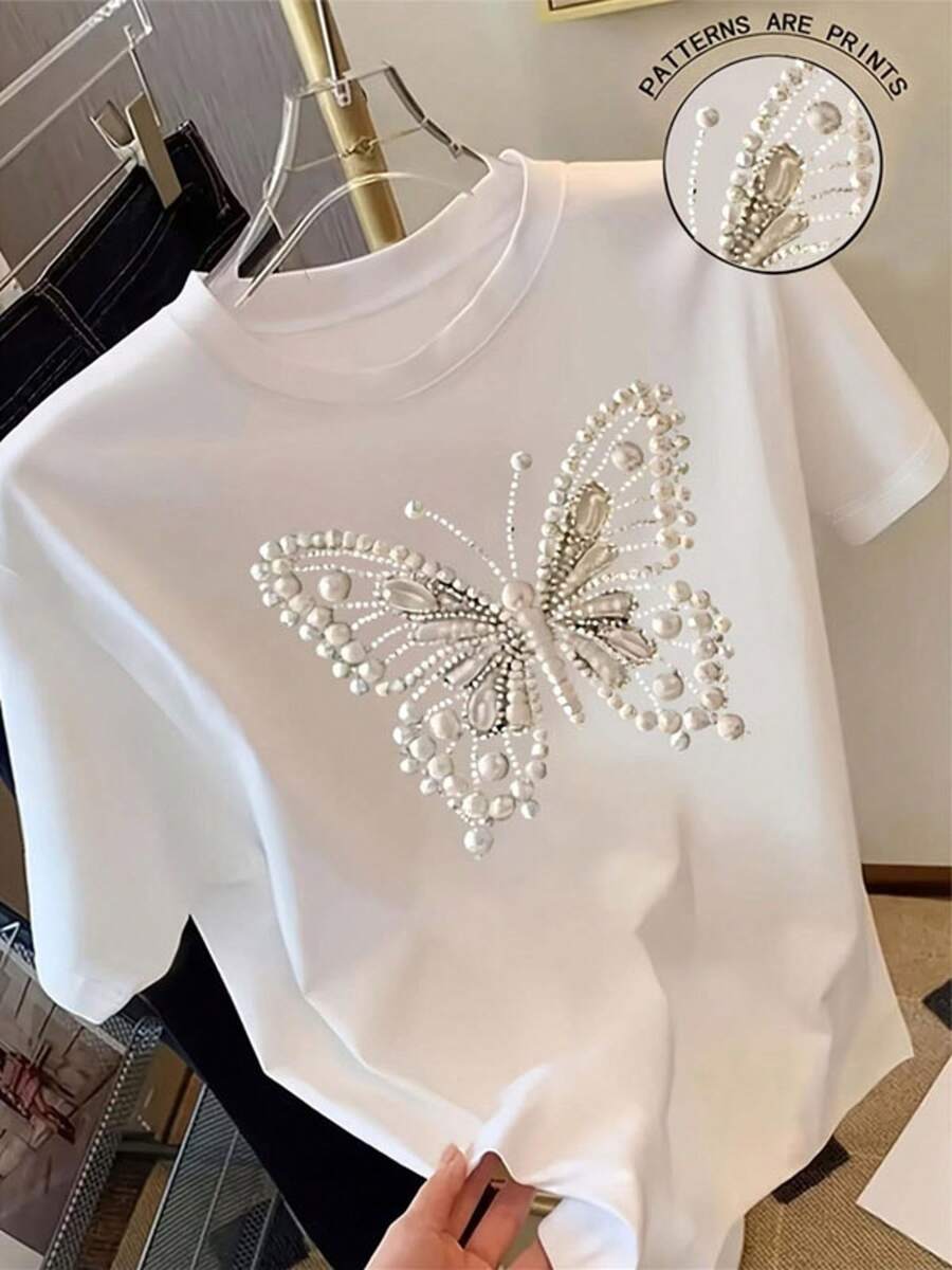 Camiseta blanca de manga corta y cuello redondo para mujer, tela de poliéster con estampado de mariposa de perla y cristal de imitación, top casual cómodo, varios tamaños disponibles, perfecta para uso diario y salidas informales - Blanco - Ver 1