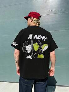 Disney Classic Playful Mickey Mouse Acrobatic Graphic T-Shirt, Green Shorts Mickey Figure With Handwritten MICKEY Font Back Print Short Sleeve T-Shirt, Black Timeless Crew Neck Casual Top, Matching Mini MICKEY Font Chest And Sleeve Two-Sided Print Detail, Soft Skin-Friendly Breathable High-Quality Cotton Fabric Construction, Reinforced Seams For Durable Long-Term Daily Use, Casual Street Life Everyday Holiday Daily Outfit, Matching Clothing For Young Adults And Couples, Iconic Disney Mickey Mouse Cartoon Character-Centered Design, Casual Urban Visual Style Suitable For Everyday Scenarios, City Meetups, Leisure Events, And Comfortable Everyday Design - màu đen - Xem 2