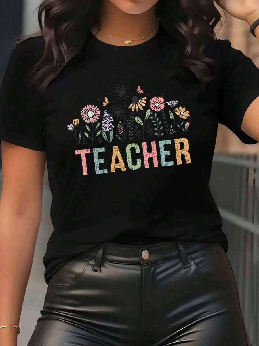 Camiseta de manga corta para mujer con estampado floral de "TEACHER", fondo negro y dise￱o de flores brillantes. Ropa casual ideal para profesores, ligera y c￳moda, perfecta para el uso diario.
