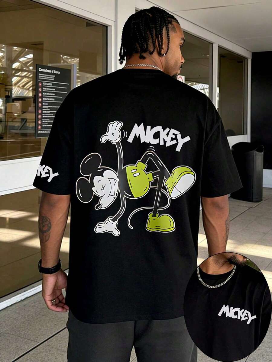 Disney Classic Playful Mickey Mouse Acrobatic Graphic T-Shirt, Green Shorts Mickey Figure With Handwritten MICKEY Font Back Print Short Sleeve T-Shirt, Black Timeless Crew Neck Casual Top, Matching Mini MICKEY Font Chest And Sleeve Two-Sided Print Detail, Soft Skin-Friendly Breathable High-Quality Cotton Fabric Construction, Reinforced Seams For Durable Long-Term Daily Use, Casual Street Life Everyday Holiday Daily Outfit, Matching Clothing For Young Adults And Couples, Iconic Disney Mickey Mouse Cartoon Character-Centered Design, Casual Urban Visual Style Suitable For Everyday Scenarios, City Meetups, Leisure Events, And Comfortable Everyday Design - màu đen - Xem 1