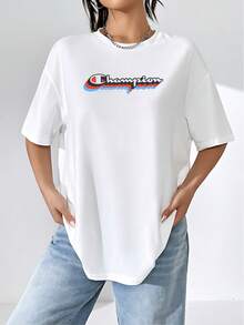 El logo tridimensional de Champion evoca un sentido de dinamismo y victoria, con capas de rojo, azul y negro que simulan movimiento y profundidad. Este distintivo gráfico no solo representa la marca sino también la perseverancia y el espíritu competitivo. La camiseta de mujer es cómoda y transpirable, ideal para el uso diario o para actividades deportivas, destacando la calidad y el confort en cada uso. - Blanco - Ver 1