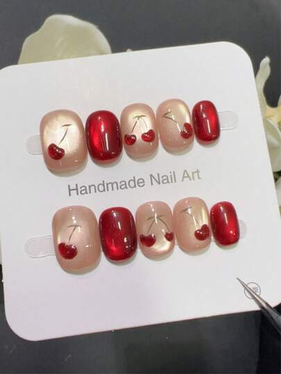 10pcs Pure Handmade Press On Nails Short Nails Oval Nails The Design Features Cherry Red And Nude Pink Cat Eye. Hand-Painted Three-Dimensional Cherries Are Combined With Green Fruit Stems, Creating A Retro And Sweet-Cool Look.Gentle Elegant Cute Nails For Ladies And Girls Spring Summer Fall Winter Festivals Parties And Daily Life Use