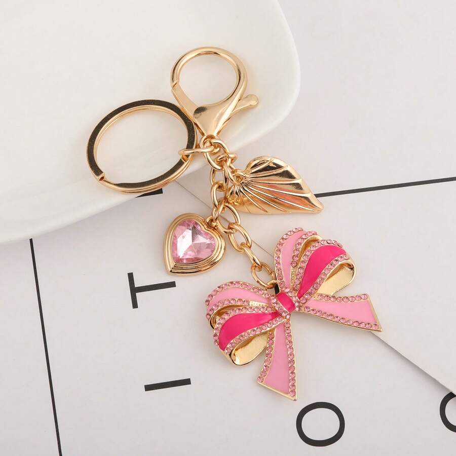 Llavero con colgante de corazón con strass en forma de lazo rosa, accesorio brillante y femenino ideal como regalo para fiestas y cumpleaños