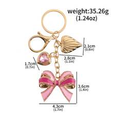 Llavero con colgante de corazón con strass en forma de lazo rosa, accesorio brillante y femenino ideal como regalo para fiestas y cumpleaños - Multicolor - Ver 10
