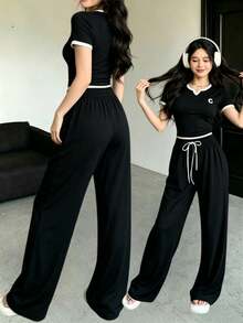The Best Gift For Mother's Day: Women's 2-Piece Activewear Set With A Round Neck, Short-Sleeved Top, And Long Pants. A Minimalist, Solid-Color Short-Sleeved Top And Pants Set. Casual Outfit. - 黑色 - 查看 1