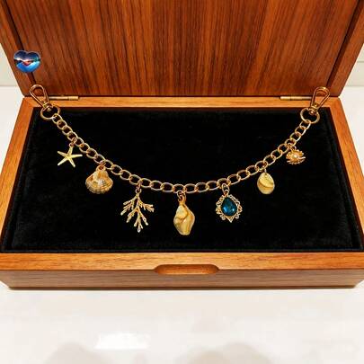 Cadena de bolso de estilo vintage con colgante de estrella de mar, concha y perla en color dorado