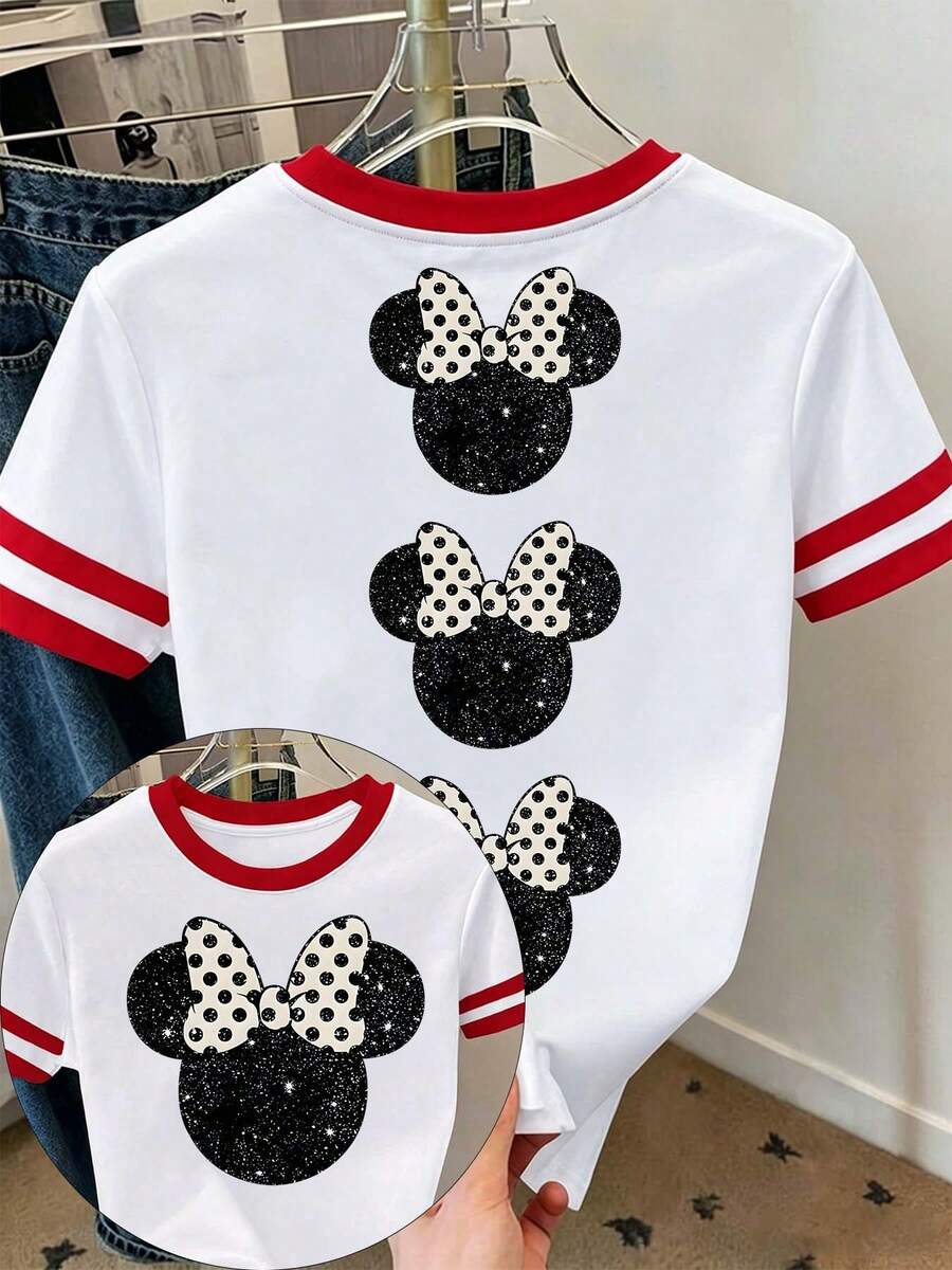 [Disney Official Authorization] Women's Casual Short Sleeve Round Neck Graphic Tee Top, Stylish Knitted Fabric T-Shirt With Print For Everyday Wear Disney Land .The Print Features A Black, Glitter-Textured Silhouette Of Minnie Mouse's Head, Paired With An Off-White, Polka-Dotted Bow.Cartoon Loose Fit Versatile Couple And Family Matching Round Neck Short Sleeve T-Shirt Top - trắng - Xem 1