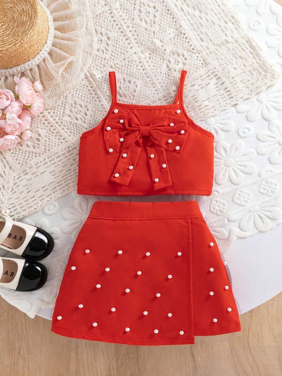 Completo estivo da ragazza composto da top a canottiera con fiocco e perle finte abbinato a una gonna decorata con perle finte, adatto per uso quotidiano, all'aperto, a scuola, per gli spostamenti, per le vacanze, per la fotografia, per feste, per l'uso in strada - Rosso - Visualizzare 1