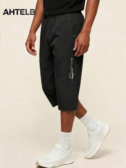  AHTELB Men's Summer Thin Ice Silk 3/4 Pants, Loose Straight Casual Mid-Length Trousers, Elastic Waist Design, Breathable Quick-Dry Fitness Pants, Anti-Theft Zipper Design, Side Printed Pattern, Suitable For Outdoor Leisure, Daily Commute And Jogging Workout Sports