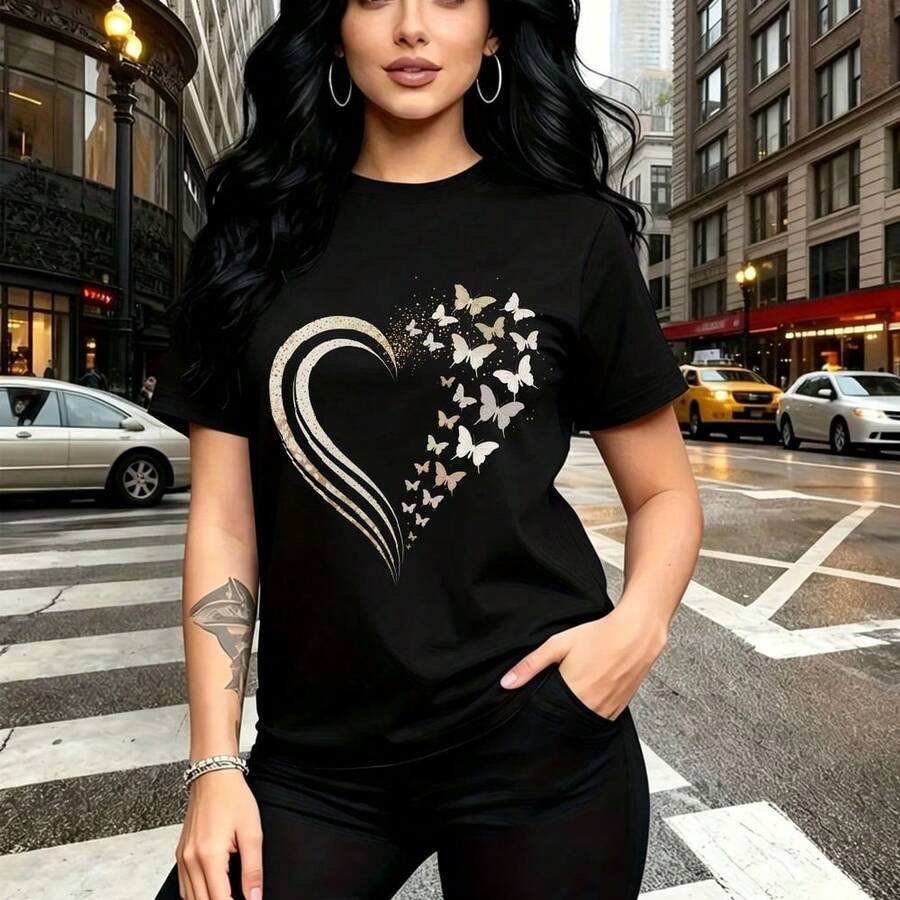 Camiseta de mujer con estampado artístico de corazón rompiéndose en mariposas blancas y brillos - camiseta casual de manga corta con cuello redondo, ajuste cómodo y estilo urbano moderno - ideal para paseos por la ciudad, salidas diarias y regalo per - Negro - Ver 1