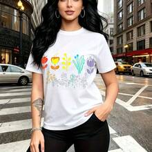 Camiseta de mujer con estampado de flores coloridas y frase "be beautiful" en cursiva blanca - camiseta casual de cuello redondo, ajuste cómodo y moderno, estilo urbano y vibrante para la ciudad - ideal para salidas diarias, paseos por el centro y re - Blanco - Ver 8