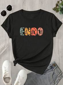 Top de mujer de manga corta y cuello redondo con estampado floral y de hojas sobre fondo naranja, apto para todas las estaciones. - Negro - Ver 1