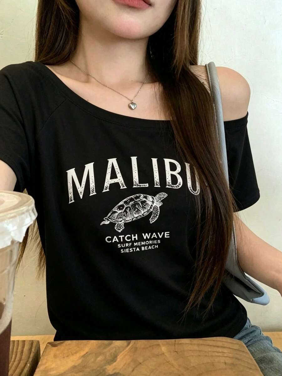 時尚女款露肩短袖T恤,裝飾馬里布海龜圖案,聚酯纖維高彈性修身下擺上衣 - 黑色 - 查看 1