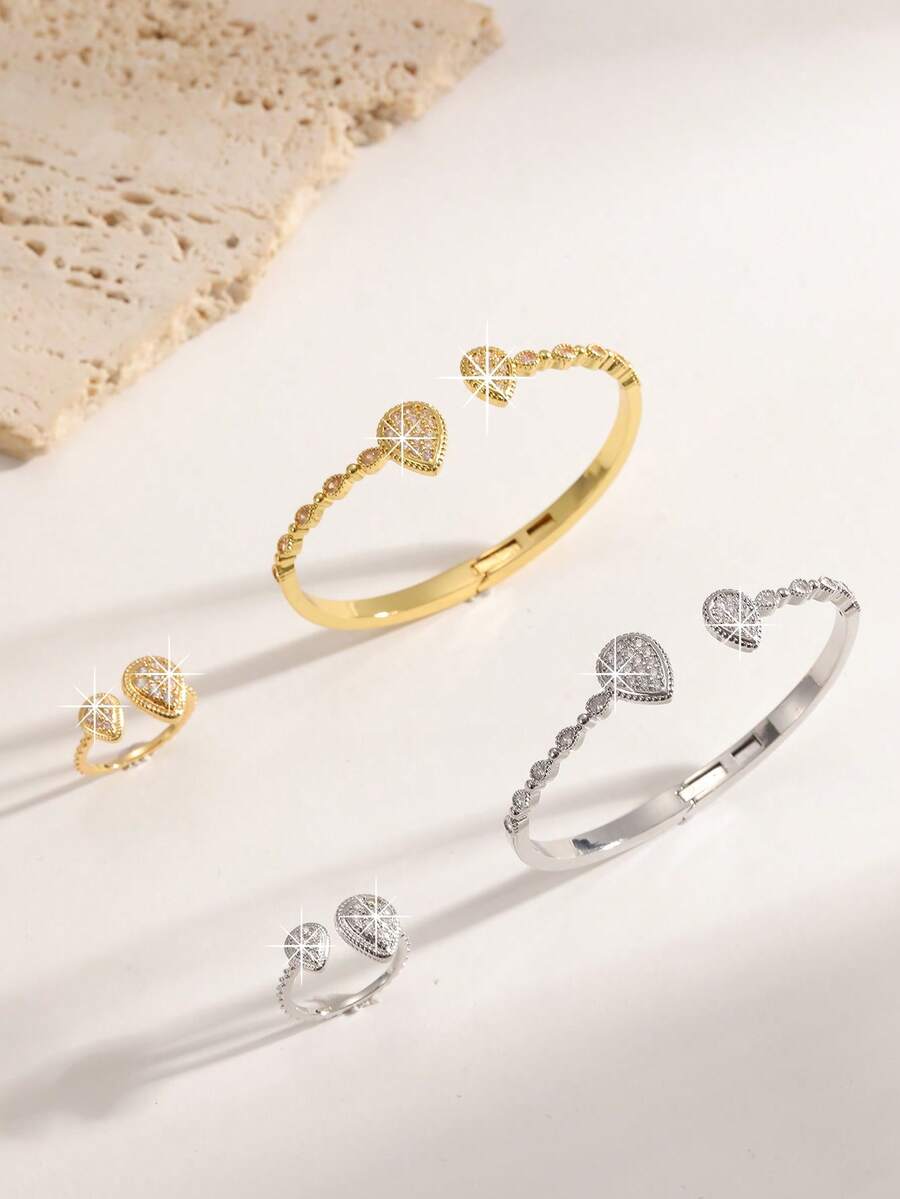 Un conjunto de joyería de lujo ligero, elegante y exquisito, chapado en oro y plata, densamente incrustado con gotas de agua del tamaño de diamantes, un conjunto de brazalete y anillo decorativo de circonita, adecuado para fiestas de gala, uso diario y regalos de vacaciones para mujeres. - Gotas de agua dobles, grandes y pequeñas - Ver 1