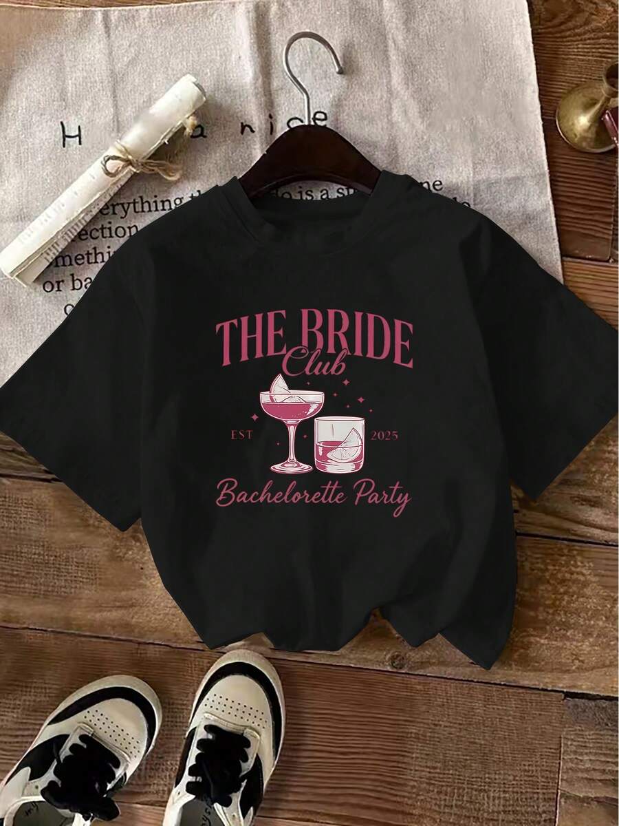 Minimalist. 100% Cotton. 1 Piece. Plus Size. Vintage-Style Wedding-Themed T-Shirt With Hand-Drawn Illustrations Of Wine Glasses: A Flute With Ice Cubes And Cherries, A Square Glass With A Lemon Slice, "THE BRIDE" Lettering, And "2025 Bachelorette Party" Text. This Spring-Summer Pink Top - Black - View 1