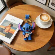 Miniso Móc khóa hình nhân vật hoạt hình Disney Stitch, chất liệu cao su mềm 3D, chế tác chi tiết cao cấp, thân màu xanh tai hồng, thiết kế nhiều tư thế vui nhộn (bóng rổ, guitar, tráng miệng), phong cách dễ thương năng động, phù hợp làm charm túi xách, mặt treo ba lô, móc khóa quản lý chìa khóa - Kiểu 3 - Xem 2