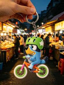 Bluey Themed 2D Cycling Adventure Keychain, Featuring The Beloved Blue Dog Riding A Colorful Bike With A Green Star Helmet. Made Of Durable, Smooth-Finish PVC With Vibrant, Non-Fading Details, It Comes With A Sturdy Metal Keyring - Multiple Styles - View 5
