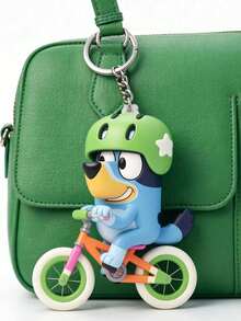 Bluey Themed 2D Cycling Adventure Keychain, Featuring The Beloved Blue Dog Riding A Colorful Bike With A Green Star Helmet. Made Of Durable, Smooth-Finish PVC With Vibrant, Non-Fading Details, It Comes With A Sturdy Metal Keyring - Multiple Styles - View 2