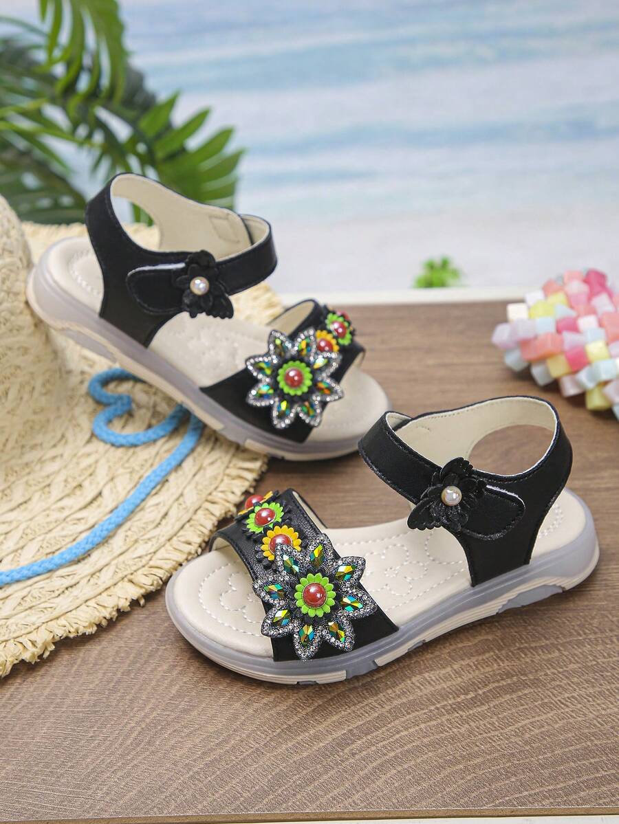 1 par de sandalias planas casuales de verano para niña bebé, para salir y escuela, con punta abierta, suela blanda, cierre de gancho y bucle, diseño de girasol con lindos strass, cómodas - Negro - Ver 1