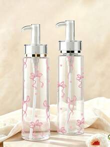 蝴蝶結紋理透明壓式壓克力乳液分裝瓶，提供100ml、120ml、150ml、200ml多種尺寸。瓶身由透明塑料材質製成，適用於分裝水性乳液、各種化妝品和化妝水，是旅行和出差的理想便攜容器。 - 彩色 - 查看 1
