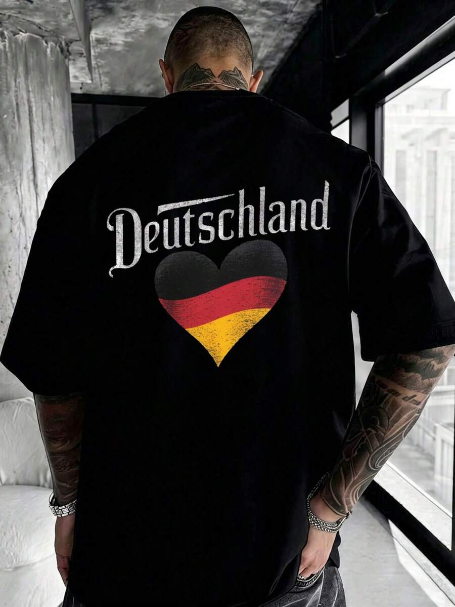 Camiseta unisex de nuevo estilo con estampado divertido de la bandera alemana en forma de corazón en la parte trasera, con el texto "Deutschland" en negro y un corazón colorido, adecuada para uso casual, regalo navideño, 100% algodón, ropa versátil para el día a día, moderna de manga corta, a la moda. - Negro - Ver 1