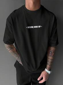 Men's Never Give Up Motivational T-Shirt - Oversized Street Style Summer T-Shirt With The Words "Never Give Up" Printed On It. Loose Fit, Crew Neck, Short Sleeve Casual Top, Suitable For Gym And Everyday Wear (Machine Washable). - Black - View 3