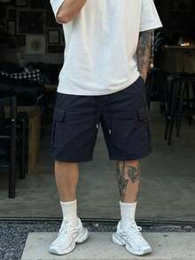 Pantaloncini cargo da uomo per sport all'aperto in tessuto intrecciato, vestibilità ampia con vita con coulisse, design con tasche multiple e patta, pantaloncini casual da streetwear e trekking - nero - Visualizzare 1