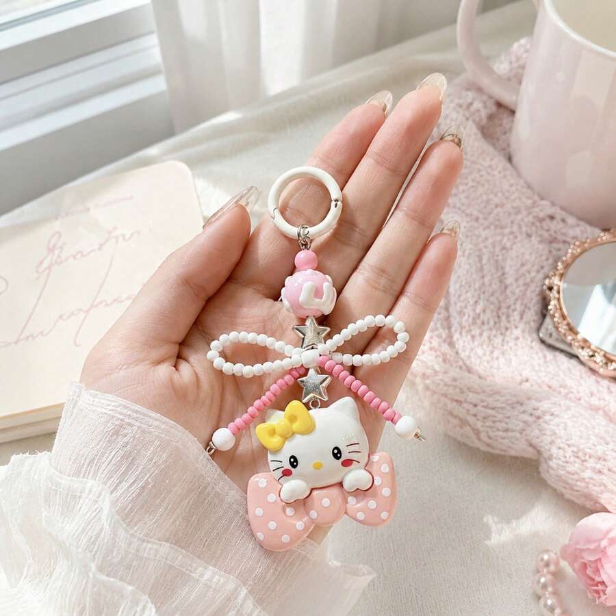 MINISO Sanrio Hello Kitty 黃色蝴蝶結串珠鑰匙圈,可愛角色迷你公仔包飾吊飾,附粉色波點蝴蝶結吊墜、粉白珍珠珠蝴蝶結掛繩、星星吊飾與白色圓環,背包手提包配件,開學禮物 - 黃色 - 查看 1