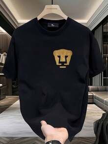 Camiseta 100% Puras con Estampado de Logo de Cabeza de León Dorado, Estilo Casual Simple, Suave y Cómoda, Cuello Redondo, Manga Corta, Moda Urbana para Todas las Estaciones, Camiseta Casual - Negro - Ver 1