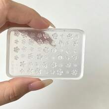 1件多尺寸小花矽膠美甲壓花模具，平板式佈局含大小五瓣花、多層花瓣與細小花朵壓紋溝槽，柔軟可彎曲矽膠易壓印且完整脫模，不撕裂不黏膠，溝槽深度均勻適合填入美甲膠打造3D立體花瓣紋理，平板表面無毛邊殘渣，易擦拭清潔重複使用，薄板可微彎貼合指甲弧面進行造型，適合美甲店量產溫柔風3D花卉美甲 - 彩色 - 查看 7