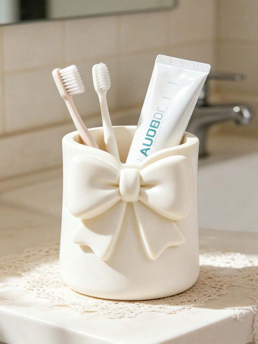 Mini Cream-Colored Bow-Shaped Creative Toothbrush Holder, Can Be Used As A Toothbrush Cup Or Desktop Storage Organizer. It Can Hold Toothbrushes, Toothpaste And Other Items. At The Same Time, It Can Also Be Used As A Flower Pot Or Vase To Add Decorative Effect To The Vanity, Making It An Ideal Choice Among Bathroom Supplies. Perfect For Creating A Warm Home Bathroom Atmosphere, And Also An Ideal Choice For Autumn Decor And Back To School Season. - Multicolor - View 1