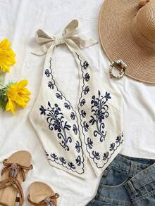 Top corto con cuello halter, espalda descubierta y lazo, con bordado floral sobre base color albaricoque, adecuado para festivales de música - Azul marino - Ver 1