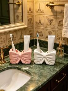 1pc Cute Bow-Shaped Toothbrush Holder, White & Pink Toothpaste Storage Rack, Bathroom Storage Shelf, Vanity Countertop Organizer, Home Bathroom Decor Accessory - Multicolor - View 1