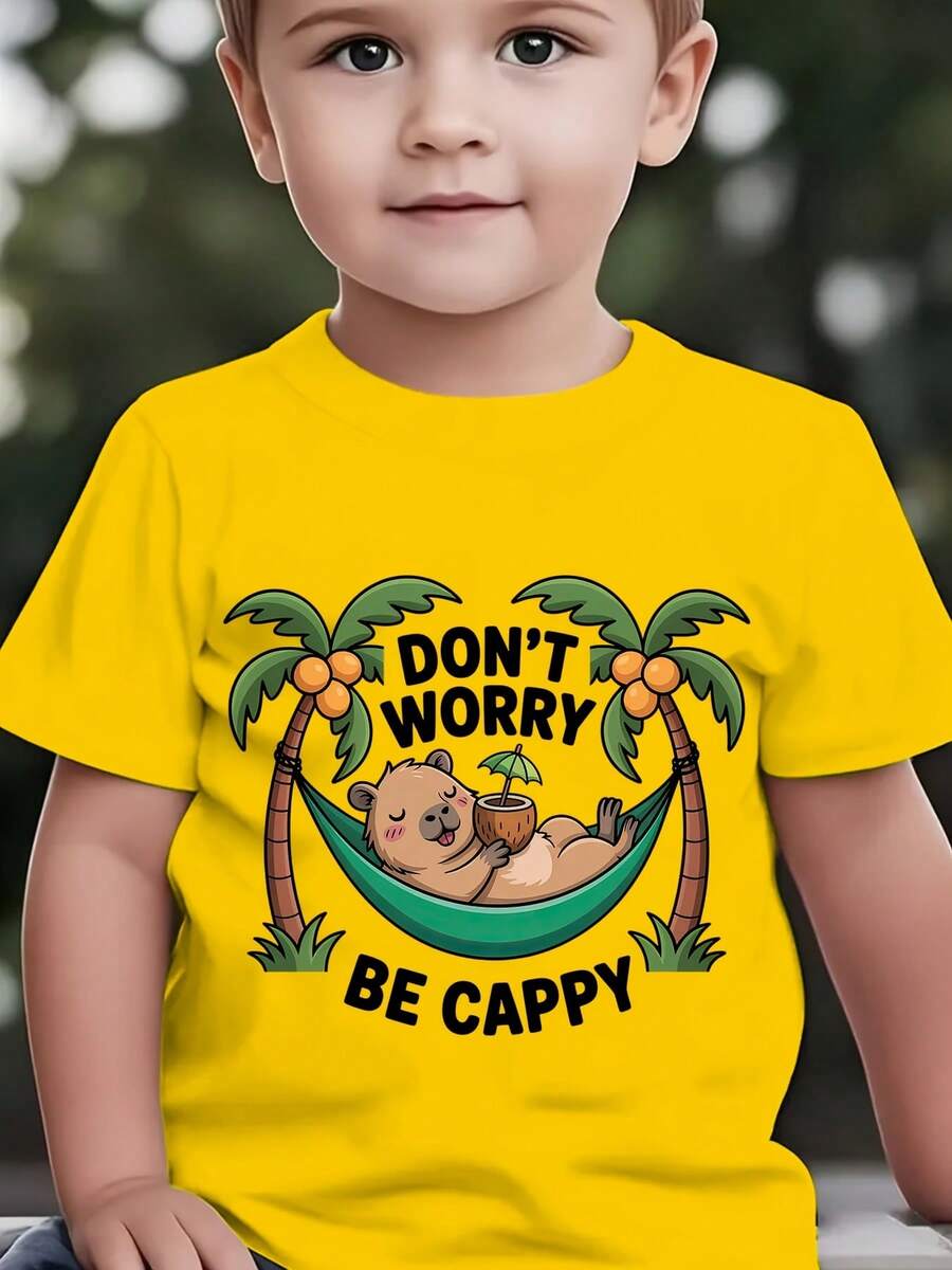 Fashionable Short-Sleeved T-Shirt For Children In Summer With The Print "DON'T WORRY BE CAPPY" And A Cartoon Capybara Lying In A Green Hammock Among Coconut Trees, Casual Top For E - 黃色 - 查看 1