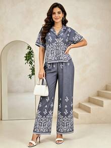 Conjunto dos piezas top asimétrico con recorte y pantalones anchos de talle alto, tejido estructurado, silueta alargante ideal para salidas nocturnas y eventos casuales - Azul oscuro - Ver 1