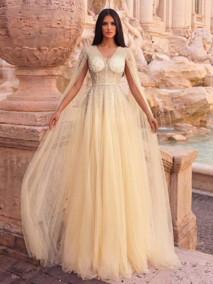 Gaun elegan berpotongan V dalam dengan korset berhiaskan manik-manik, rok model A-line, dan detail rhinestones, cocok untuk sesi foto, acara malam formal, karpet merah, dan perayaan besar.