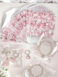 100个方形花卉图案自粘糖果袋 - 一次性塑料包装，适用于蛋糕、巧克力和糖果 - 非常适合万圣节、圣诞节、感恩节、零食储存 | 节日设计袋 | 塑料拉链袋 - 淺粉色 - 查看 1