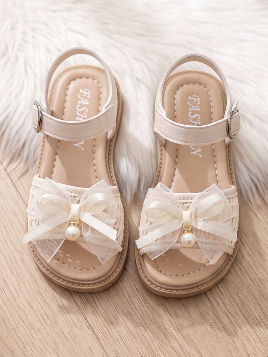 Sandalias de moda con lazo de cinta beige para niñas verano 2026, zapatos elegantes de princesa para niñas de 3-10 años, zapatos planos cómodos y transpirables con punta abierta, zapatos infantiles con cierre de gancho y bucle ajustable fáciles de poner y quitar, zapatos ligeros y versátiles duraderos para estudiantes, adecuados para la escuela, cumpleaños, bodas y uso diario! - Beis - Ver 1