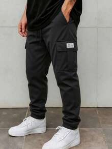 Pantalon cargo ample pour hommes, design robuste à plusieurs poches, style avec lien à la cheville, tenue décontracté à la mode pour le printemps et l'automne - Noir - Voir 1