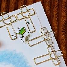 15/25pcs Heart Cross Shaped Paper Clips, Hollow Heart Cross Line Solid Color Metal Design, Cross Hollow Paper Clip Shape, Room Decor, Office Desk Accessories - Gold - View 1